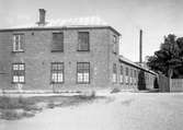 Svenska Tagelspinneriet år 1933. Fabriken låg ett stenkast bortom den putsade tegelbyggnad som ligger på Tolvmansgatans högra sida. Se kommentarer.