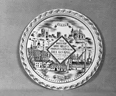 AB Gefle Porslinsfabrik
Minnestallrik för 60-årig framgångsrik verksamhet till Ahlgren.