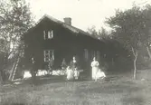 En familj står uppställd framför sitt hem Viborg 1913.