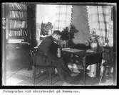 Fotografen vid skrivbordet på kammaren.