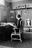 John Bauer sitter och tecknar vid skrivbordet i sin ateljé i sitt föräldrahem Sjövik i Jönköping.