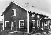 Första Konsumaffären i Hedesunda 1925.
Vid ingången till bostadsdelen syns förste föreståndaren Oskar Wiklund. Huset inrymde tidigare målarverkstad ägd av ett flertal målare bl.a. Olsen från Norge. Wiklund flyttade till Hedesunda som målare i denna fastighet.