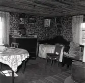 Interiör från boningshusets stora rum. Mors byrå och säng.