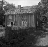 Byggnadens inre fasad med köksingången. Ursprungligt brädtak. Skorsten i kallmur.