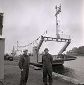 Två män som står framför vägverkets färja 296 på varvet i Kalmar.