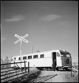 Resande stiger på rälsbuss tillhörande Statens Järnvägar,  SJ YDo1 422, på en hållplats på linjen mellan Mjölby och Hästholmen.