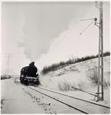 Järnvägslinje med trafikerande ånglok i närheten av Abisko.