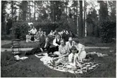 Långsjön midsommardagen 1942. Längst bak framför häcken till vänster: Lisa och Ingemar Aldenby. Längst bak från höger: Långsjö-Pelle i sin uniformsmössa och bredvid honom farfar Per Andersson och Tekla Andersson sittandes i vilstolen. I gröngräset till höger brudparet: Anders och Siri Lindgren och framför dem Björn Aldenby, son till Ingemar och Lisa.