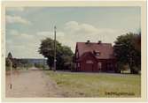 Vy vid Redvägsbrunn. Håll- och lastplats, öppnad med banan 1917. En- och enhalvvånings stationshus i trä, byggt i vinkel. Avbemannad 1958. Väntkur ej uppsatt. Tåguppehållen indrogs fr o m 17 juni 1974. Hållplats anlagd 1917  Enligt ritningar av arkitekt Rudolf Lange, Göteborg.