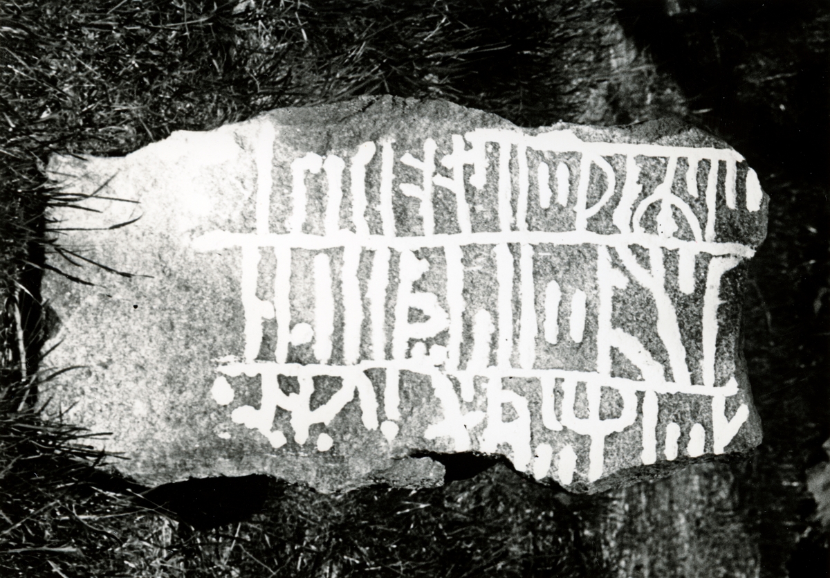 Åke Fredsjö, Enligt text: "Runstensfragment. "Tossenestenen". Fyndplats: Överby, Tossene. Runstenen grävdes ursprungligen fram i en gravhög på hemmanet Valla. Högen jämnades med marken".