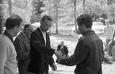 AT-skytte. Tävling. Flera personer ute i skogen.
Mannen, i mörk jacka, till vänster, kan vara Tord Wallström. Bakom honom skymtar Gunnar Tallqvist.