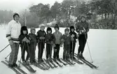Avslutning på skidskola för barn.
Två kvinnliga skidlärare och sju barn. Sjätte barnet, från vänster, är Ken Gustafsson. Anita Gustafsson är skidläraren längst till höger.