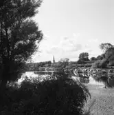 Båtar, i Arbogaån, vid bryggan nedanför Bergmanparken. I bakgrunden ses Herrgårdsbron och tornet på Heliga Trefaldighetskyrkan.
Bilden är tagen från södra sidan av ån.
