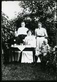 Möklinta sn, Sala.
Fyra kvinnor och en pojke vid dukat fikabord i trädgård. C:a 1900.