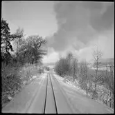 Vy över vintrigt järnvägsspår på linjen mellan Lägesta - Mariefred som användes av Museijärnväg Östra Södermanlands Järnväg, ÖSlJ.