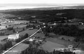 Vy över Sjösås by med Sjösås nya kyrka i förgrunden.