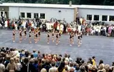 Examen och skolavslutning för elever på inre skolgården vid Brattåsskolan cirka 1970. Några elever i svarta gympadräkter gör en dansuppvisning.