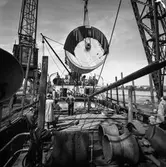 Transport av pappersbruket Papyrus PM2 yankeecylinder. Cylindern hissas upp med lyftkran i Göteborgs hamn, 2/6 1956.