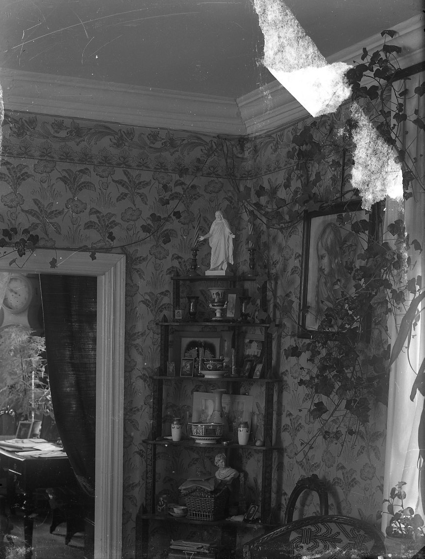 Calla Helena Sundbeck, Interior from an unknown home. A corner shelf with Christ figure at the top. Possibly interior of Miss Valborg Franck in Boundary.