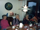Fikastund i Brattåsgårdens matsal (Streteredsvägen 5) cirka 1990. Från vänster sitter Ingrid Rosén (1904 - 2000), okänd kvinna samt Helga Påsse (1907 - 2004). I taket hänger en vit PH-lampa som formgavs 1924 av den danske arkitekten Poul Henningsen.