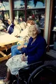 Fem kvinnor sitter och njuter av solen utanför Brattåsgården (Streteredsvägen 5), cirka 1990. Från vänster: (i glasögon, mörk jacka) Rut Göransson (1905 - 1999), Edit Bernhardsson (1911 - 2000), Maria Valvsten (1909 - 2004), vårdbiträde Agneta samt Sigrid Börjesson (1910 - 1995).