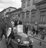 Studentfinal, 1944. 
En kvinnlig student körs iväg längs Storgatan av sina kamrater. I 
bakgrunden skymtar P.N. Perssons fastighet, 