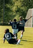 Fotbollslaget Lindome GIF spelar match mot Jitex BK i maj 2000. Möjligen på Lindevi IP i Lindome, Mölndals kommun. Slutresultatet är okänt.