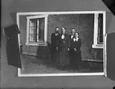 Personer framför hus