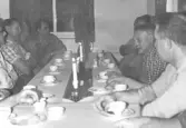 Gruppbild - Personalen vid skofabriken Ljungsko dricker kaffe vid luciafest 1964  Bild 1: Vänstra raden fr.v. Ove Karlsson,  Tage (Svensson eller Andersson), okänd, Erik Andersson. Högra raden fr h. Helge Johansson, Erik Erlandsson i rutig skjorta.   Bild 2: Sittande trea fr. v. Hugo 
