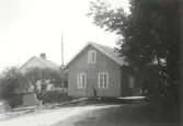 Medföljande text till fotografierna.  Fiskare flyttar sitt hus för andra gången på 30 år.År 1905 uppförde fiskare Gustav Johansson en en familjsvilla i Stafsinge, år 1926 flyttade han huset till Strandridaregatan. 16 juni 1956 flyttades huset till Sanddynevägen. Nores Gustav kunde till och med koka kaffe och laga mat under färden.