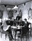 Foto av tre officerare som tar en paus i övningarna vid officersmässen i Mohed. Text i album: 