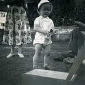 Porträtt av pojken Lennart Berndtsson i en trädgård. Prytzgatan i Broslätt, Mölndal, cirka 1955.