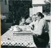 Kjellviken. Torborg vid uppdukat bord