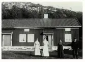Anders Anderssons gård i Drared, Veddige. Framför bostadshuset står tre kvinnor och en man. Troligen har byggnaden ursprungligen varit en högloftsstuga, då den har två ingångar, vilka varit till respektive loft med en lägre ryggåsstuga emellan. Fönstren under takfoten vittnar om att man sedan har höjt mittendelen till loftens höjd och på så sätt fått en s k loftgångsstuga med genomgående vind, vilket var ett vanligt förfarande.