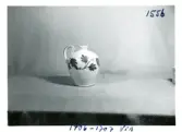 Krus i dekor Vin från Bo Fajans, formgivare Allan Ebeling, tidigt 1900-tal.