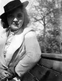 Välklädd kvinna på parkbänk i Hagaparken, 1936