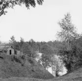 Gagnef. Överbacka. Smedja och skäl vid älven.

