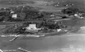 Flygfoto över Lysholmen med omgivning i Släp (Särö), sett från Skörvallaviken. Det var generalkonsul Folke Jonsson med frun Olga Dawson som 1917 flyttade till det nybyggda Lysholmen, där deras nio barn växte upp. 1932 uppfördes murarna och trädgården har även trappor mellan de olika etagen och stigar som leder ner till den vid stranden uppmurade runda ytan.
